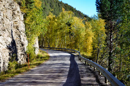 countryroad in autumnal mountain landscape, central norwayの写真素材