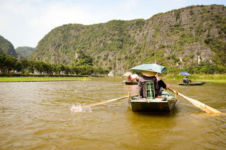 ninh bin tourist traveling through river with rowing boatsの写真素材