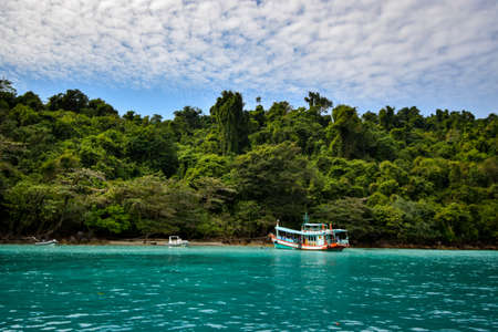 Colorful boat and jungle landscape in Thailand