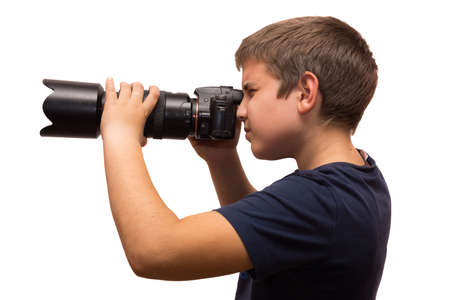 the photograph depicts a young boy with a cameraの写真素材