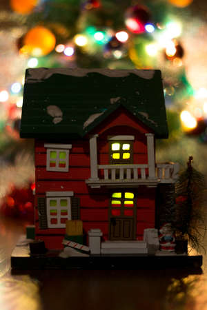 The photograph shows a house with a Christmas treeの写真素材