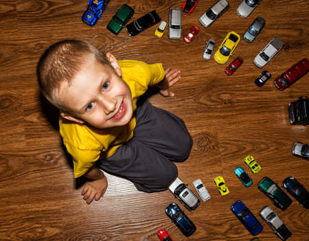 The photograph depicts a young boy with toy carsのeditorial素材