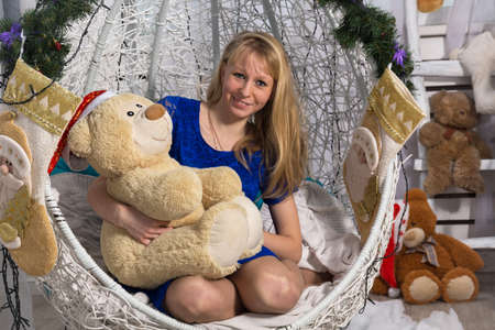 The photo shows a girl with a teddy bearの写真素材