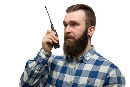 The photo depicts a man with a walkie-talkie on a white backgroundの写真素材