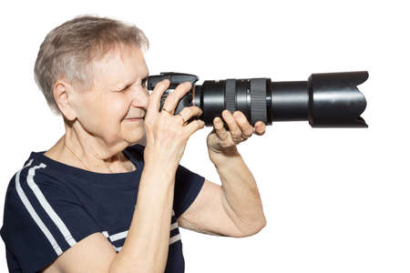 The photo shows a grandmother with a cameraの写真素材
