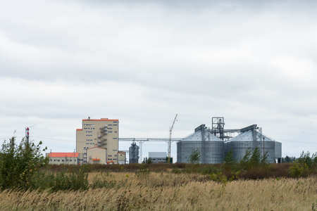 The photo depicts a flour mill at sunriseの写真素材
