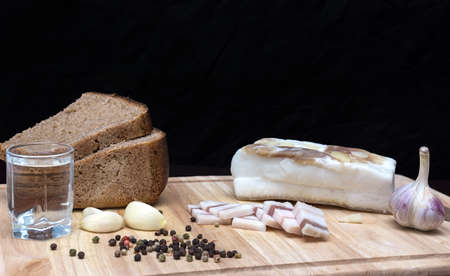 The photo shows a fat with a glass of vodkaの写真素材