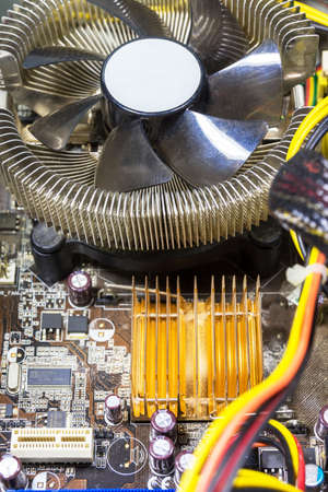 The photo shows a motherboard with a cooler