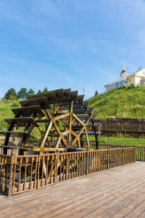 Water mill on the background of the church, Radonezh, Russia, Golden Ring, summer