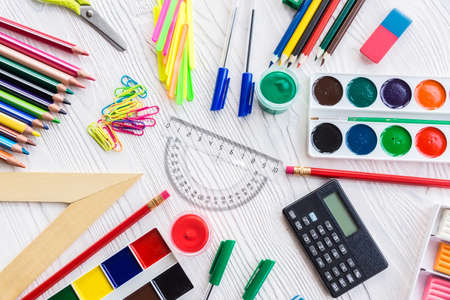 School supplies on a white background, paints and brushes