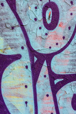 old concrete painted wall with cracks and graffitiのeditorial素材