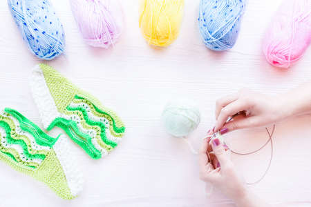 girl knits sock knitting needles on white background