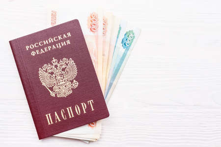 Russian passport with money on white backgroundの写真素材
