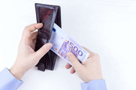 purse with money in hands on a white backgroundの写真素材