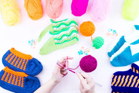 girl knits sock knitting needles on white backgroundの写真素材