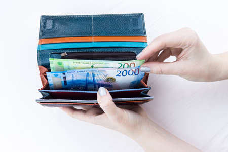 purse with money in hands on a white backgroundの写真素材