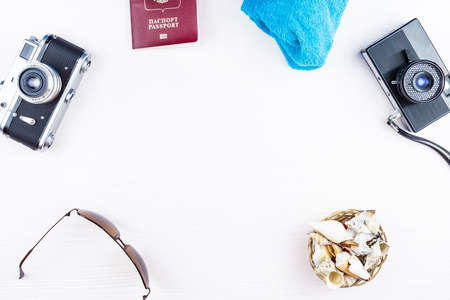 Seashells and camera on white background, passport, travelの写真素材