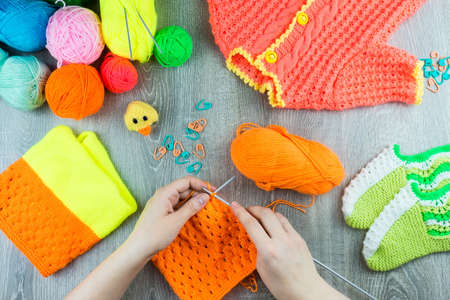 girl knits sock knitting needles on gray background