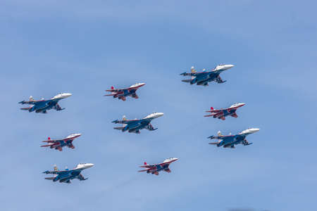 RUSSIA, MOSCOW - may 09, 2015: Parade of aviation technology for military purposes, the Russian Air Force SU-30 and MIG-29 aerobatic groups "Russian Knights and Swifts aircraft during Victory Day.のeditorial素材