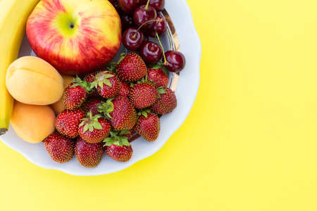 Ripe fresh fruit on a yellow background