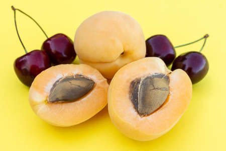 fresh ripe adriose and cherry on a yellow background