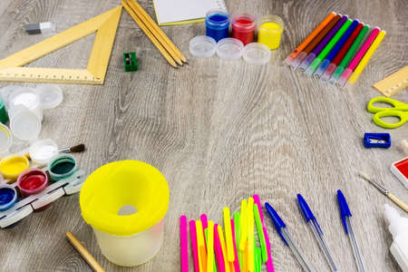 School supplies on a white background, paints and brushes