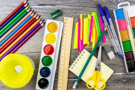 School supplies on a grey background, paints and brushesの写真素材