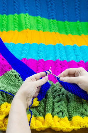 girl knits blanket knitting needles on gray backgroundの写真素材