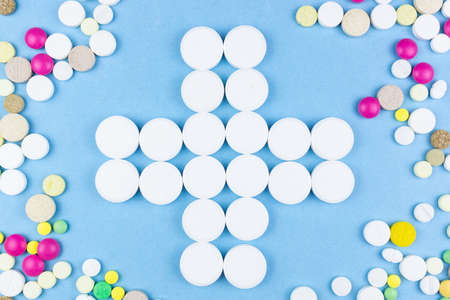 Assorted pharmaceutical medicine pills, tablets and capsules over blue backgroundの写真素材