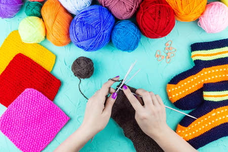 girl knits sock knitting needles on green background