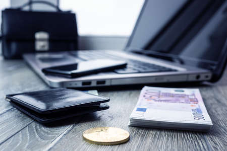Bank card and mobile phone on the laptop. Online payment and shopping. The banking application is opened on a smartphone and bitcoinの写真素材