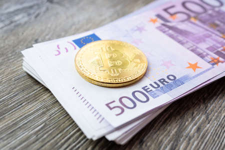 Bitcoin lies on Euro banknotes, the texture of Euro banknotes with bitcoinの写真素材