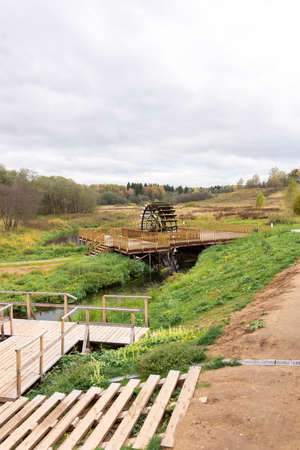 Working watermill wheel with falling water in the villageの写真素材