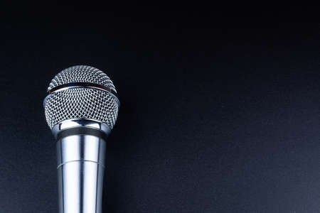 Close up of microphone on black background. Black Microphone on a pink backgroundの写真素材