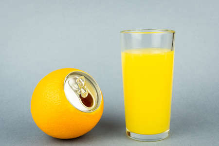 Fresh orange juice with fruits on grey background, Orange juice in glass on grey backgroundの写真素材