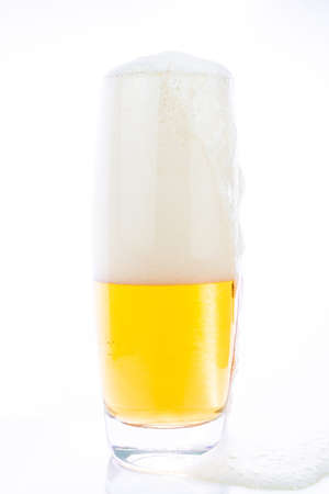 Glass of cold beer on a white backgroundの写真素材