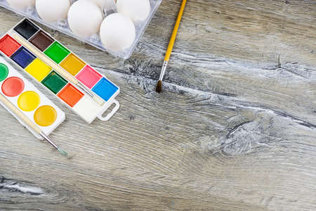 White eggs, paints, tassels, preparation for coloring for Easter.の写真素材