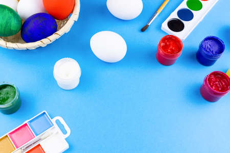 White eggs, paints, tassels, preparation for coloring for Easter.の写真素材