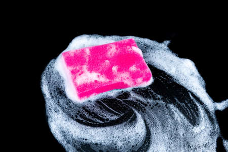 Cleaning sponge with foam for dish washing on black backgroundの写真素材
