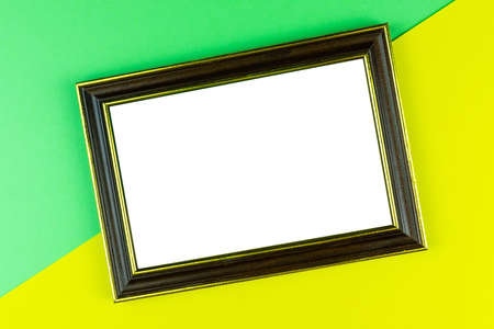 Wooden frame isolated on a yellow backgroundの写真素材