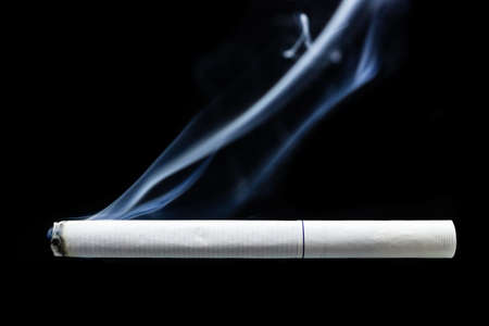 Smoke and cigarette on black background, cigarette smoke on black textureの写真素材
