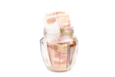Russian rouble. the money is in a glass jar. five thousand ruble on white background, Bank with...