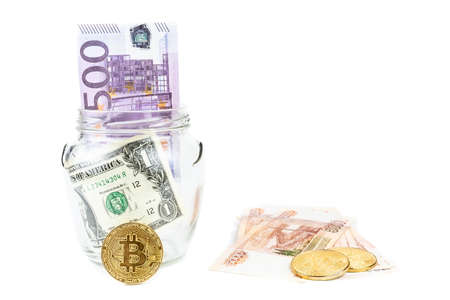 Bitcoin bronze gold coin in glass jar on white background. A set of cryptocurrencies with real...