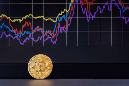 Coin Bitcoin close-up, and schedule the exchange in background.の写真素材