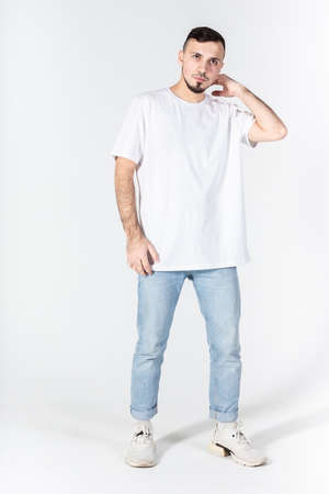 A man in a white t-shirt on a white background, Studio portrait