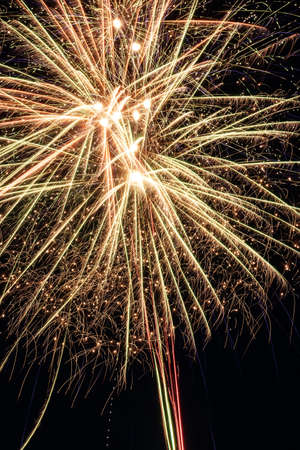 Close-up red and gold festive fireworks on a black background. Abstract holiday background