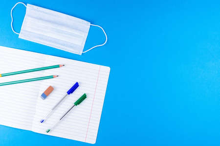 Back to school. School accessories on a blue background. photo banner, top view, space for text.