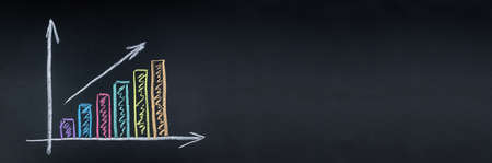 The graph shows the increase of the target drawn in chalk on the Boardの写真素材