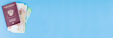 Foreign passport with money on a blue backgroundの写真素材