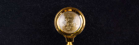 bitcoin under a magnifying glass on a black background, the growth of bitcoinの写真素材